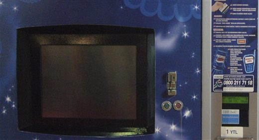 The same instructions on a machine in the field, later in the service's life: "call 8099 from your Turkcell line," the loyalty-points flow beside it — and under the display, our own label, DMS Tech Vending Solutions