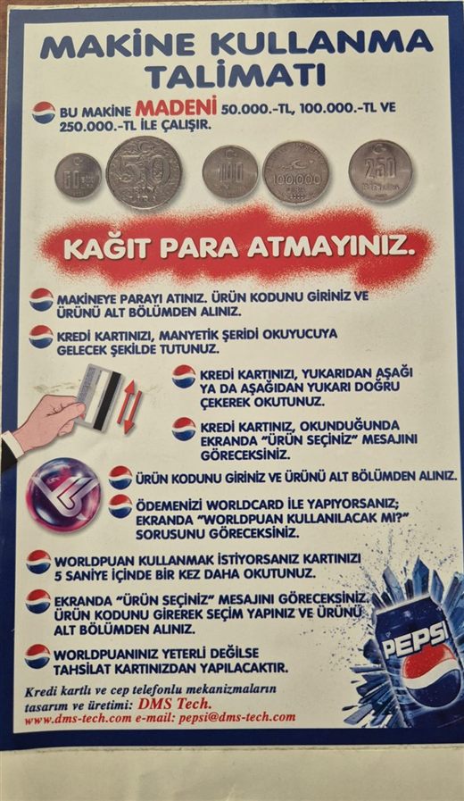 The instruction card fixed to the machine: coins, magnetic-stripe card, loyalty points — and at the foot, "design and manufacture of the credit-card and mobile-phone mechanisms: DMS Tech"